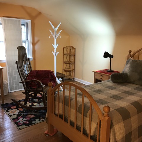 Homestay rooms have a comfy chair in addition to your bed.