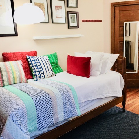 The room is fully furnished, including bedding and towels for the shower.